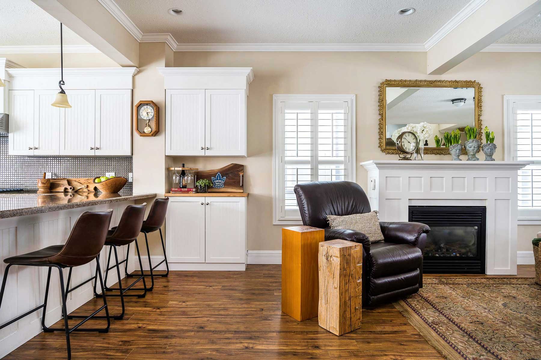 A home interior showing part of the kitchen and the living room in Collingwood Ontario. Photographed by real estate photographer Sebastian at Elevated Photos.