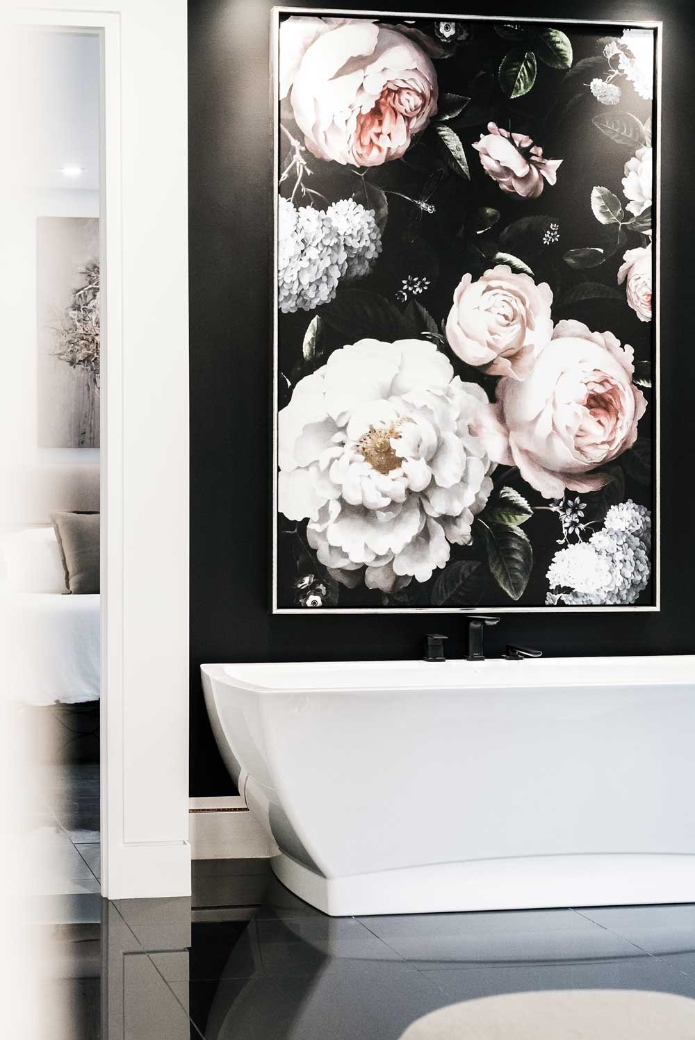 A large floral black accent wall in a bathroom of a luxury home.