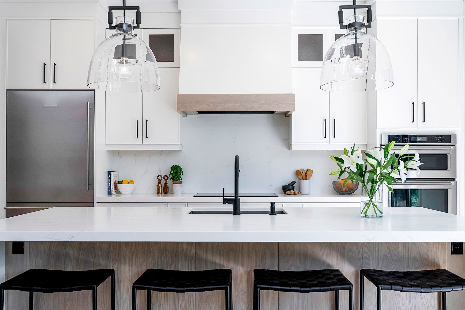 A modern kitchen island with marble backsplash in Collingwood, Ontario.