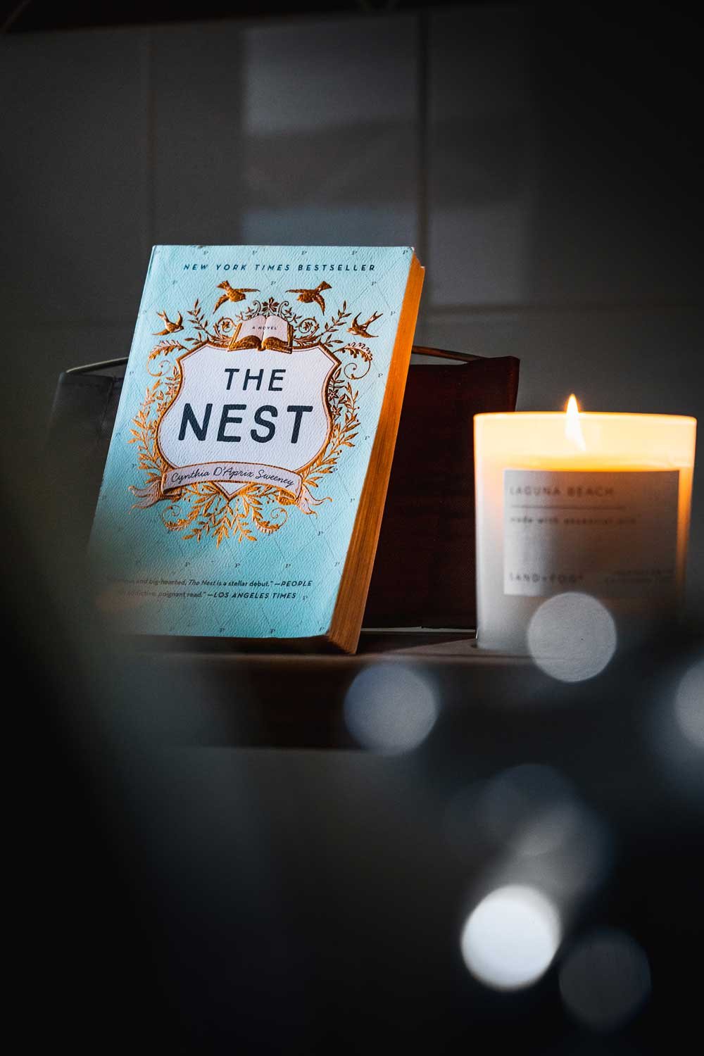 A book called the nest, used for staging a bathroom at an Airbnb rental.