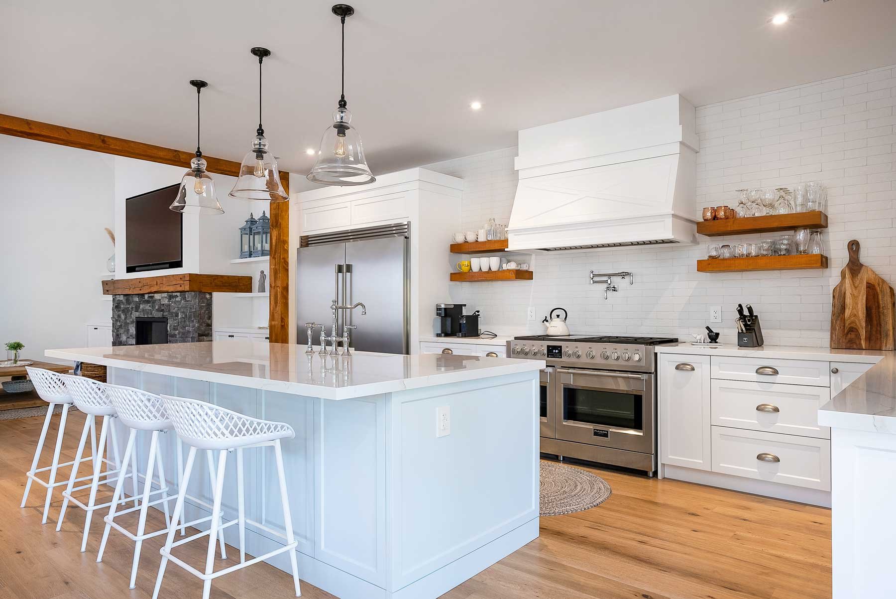 A bright white kitchen, with a large island in Wasaga Beach, Ontario.