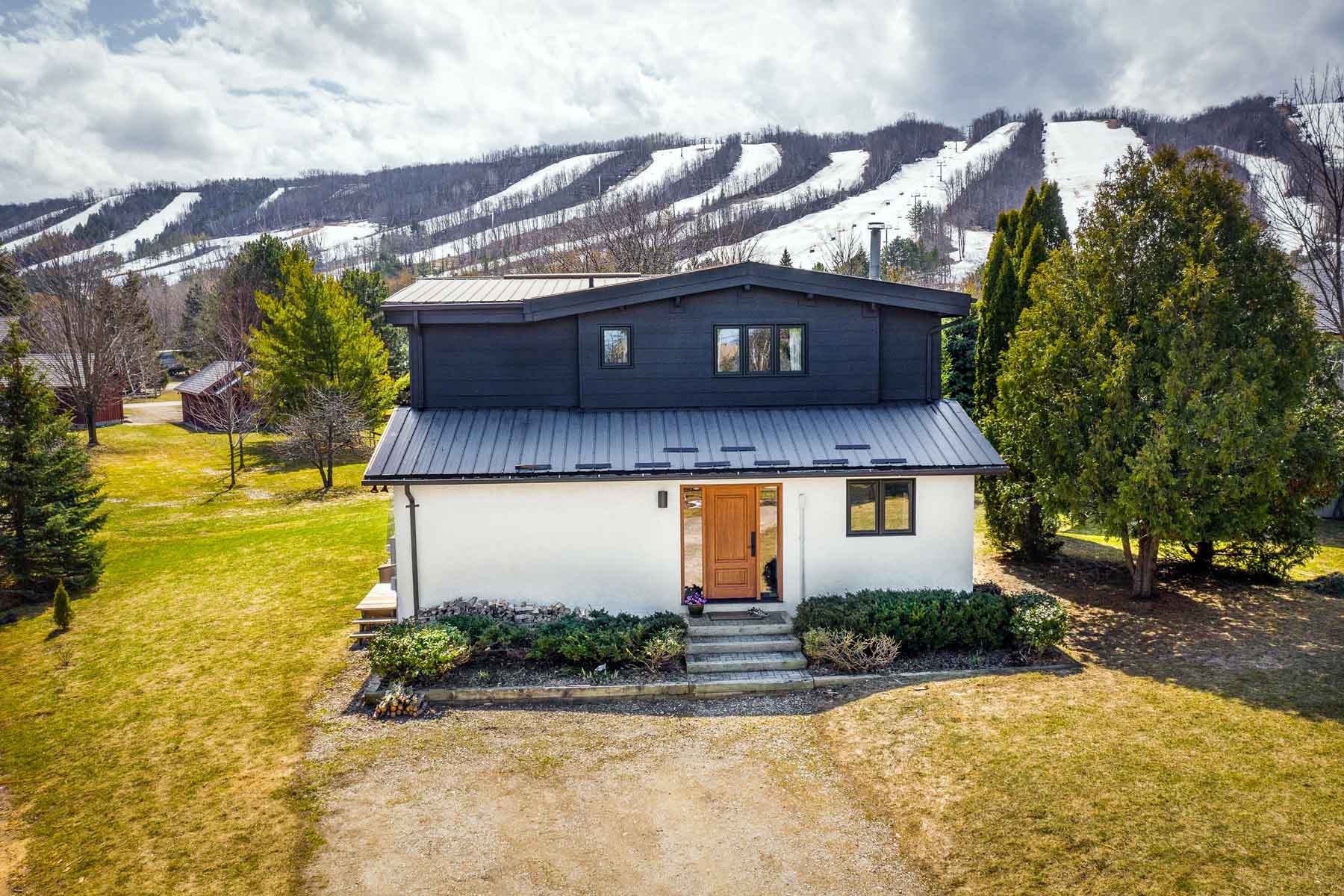 A winter chalet in The Blue Mountains with the ski hills in the background.