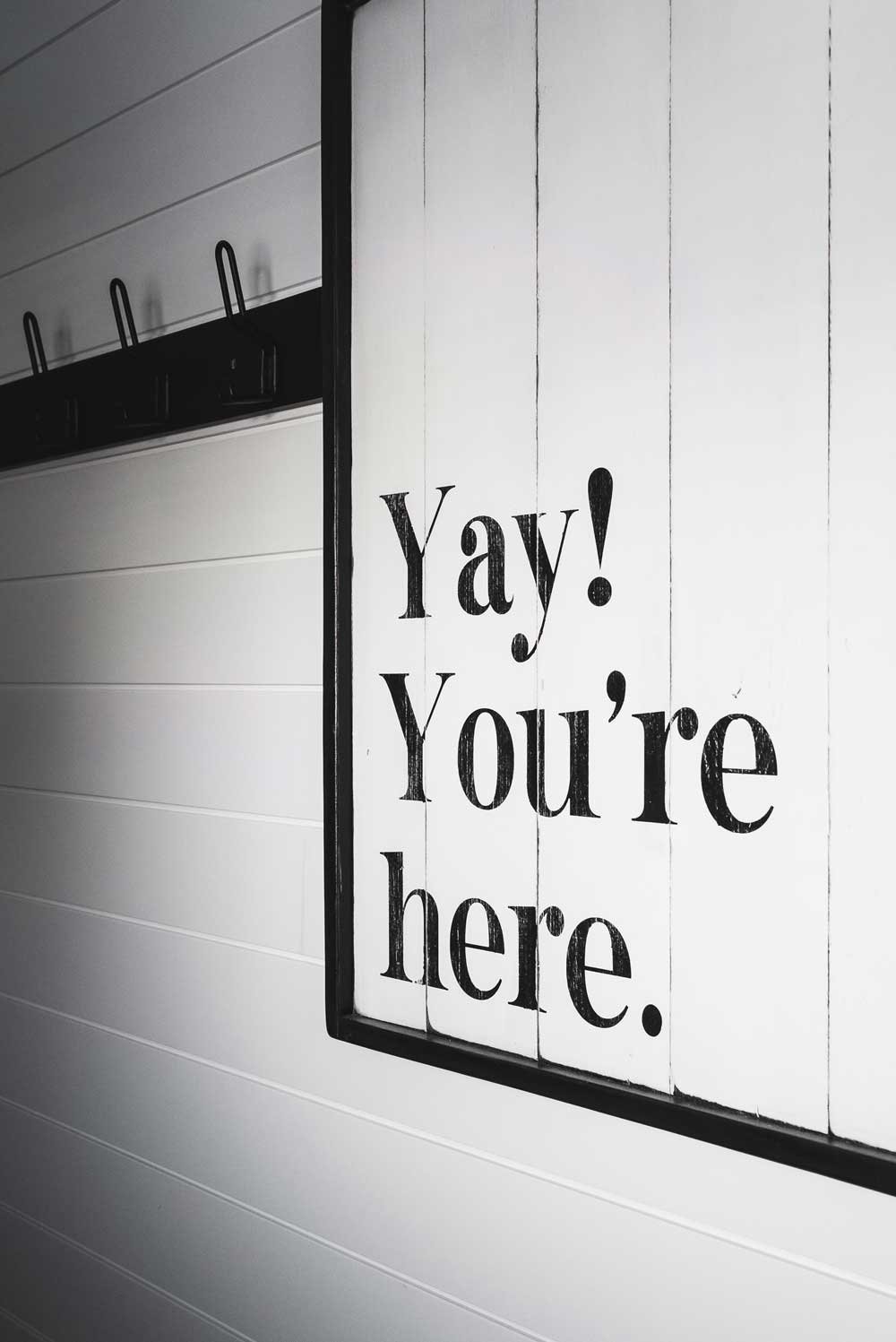 A sign for an Airbnb rental in the blue mountains that says yay, you're here.